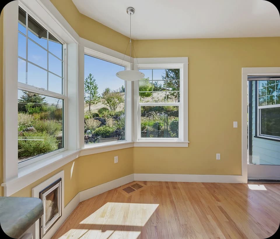 Bright living room with large modern replacement windows and natural daylight